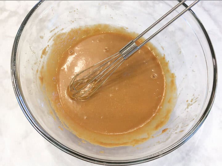 Mixing the dressing in a bowl.