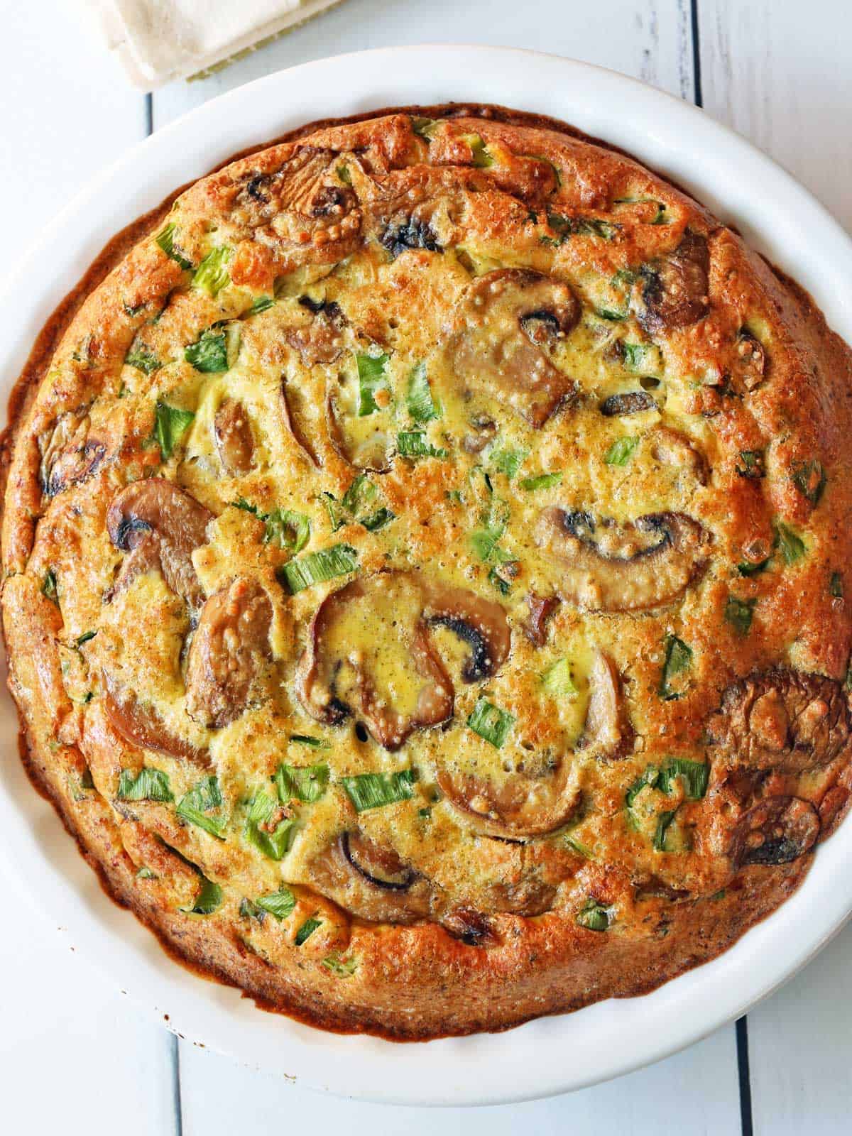 Mushroom frittata is served in a pie plate.