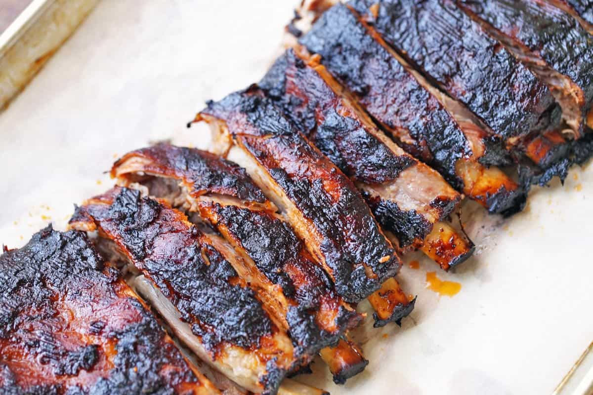 A sliced rack of oven baked pork ribs.