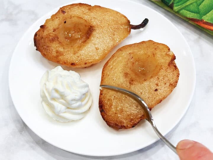 The pears are served with whipped cream.