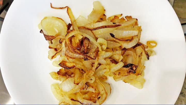 Sauteed onions on a white plate.