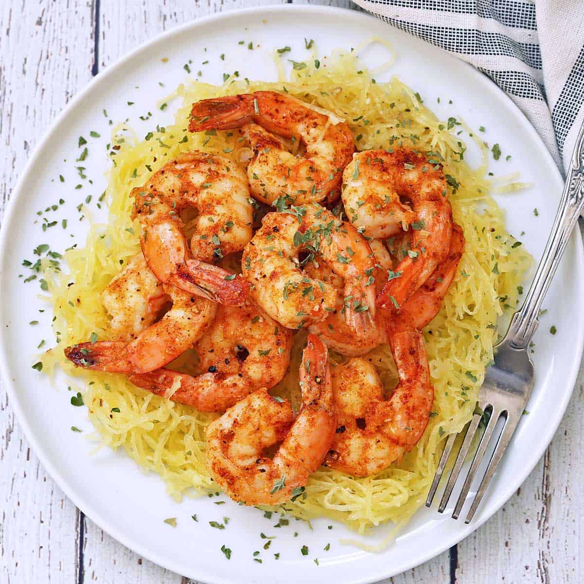 Sauteed shrimp are served on to pof spaghetti squash.