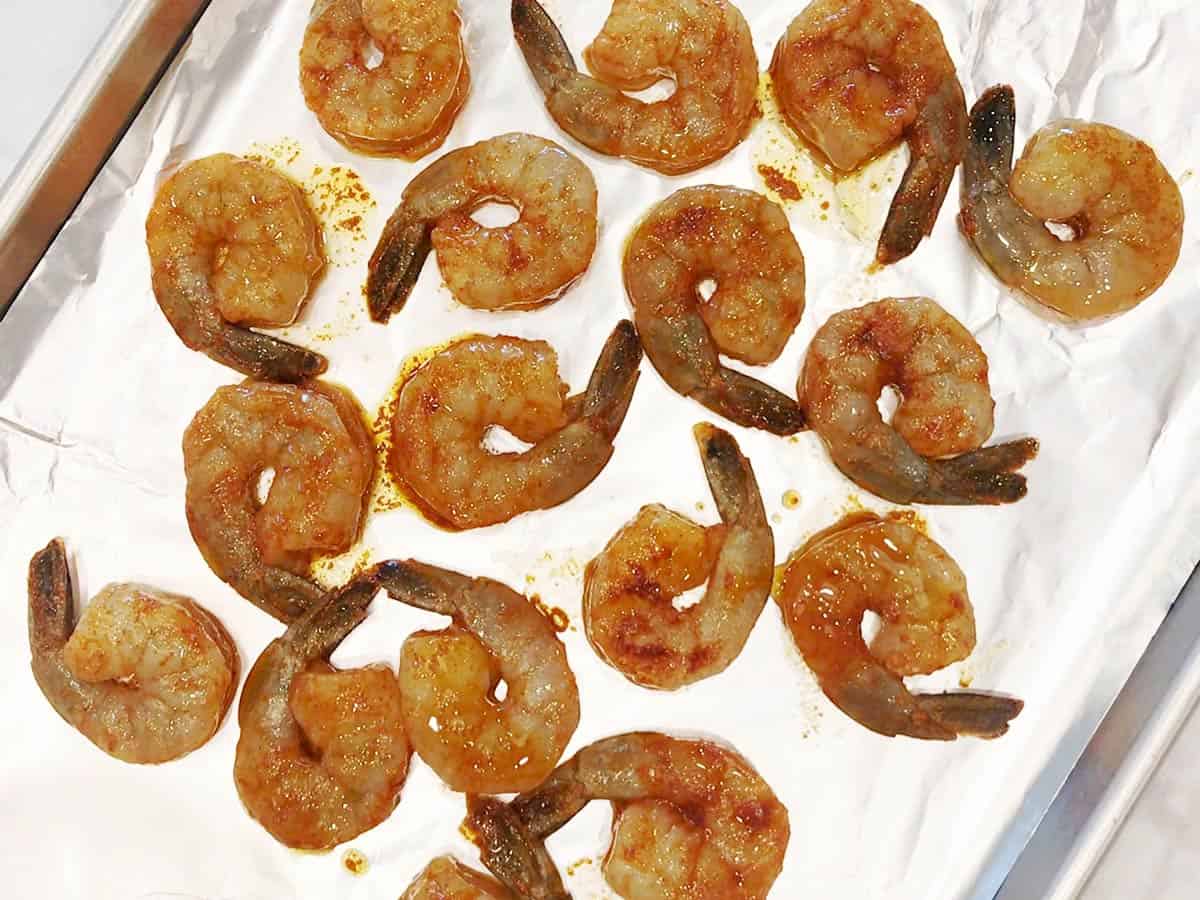 The shrimp were arranged on a foil-lined baking sheet.