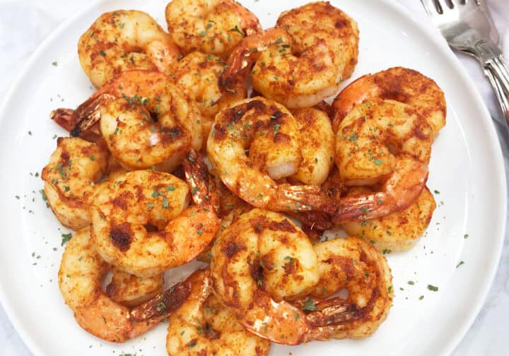 The shrimp are served on a white plate.