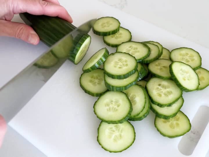 Slicing the cucumber.