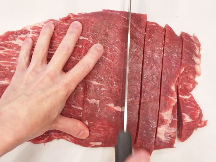 Slicing the beef into strips.