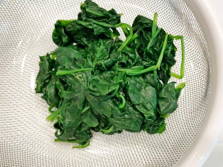 The spinach was placed in a strainer.