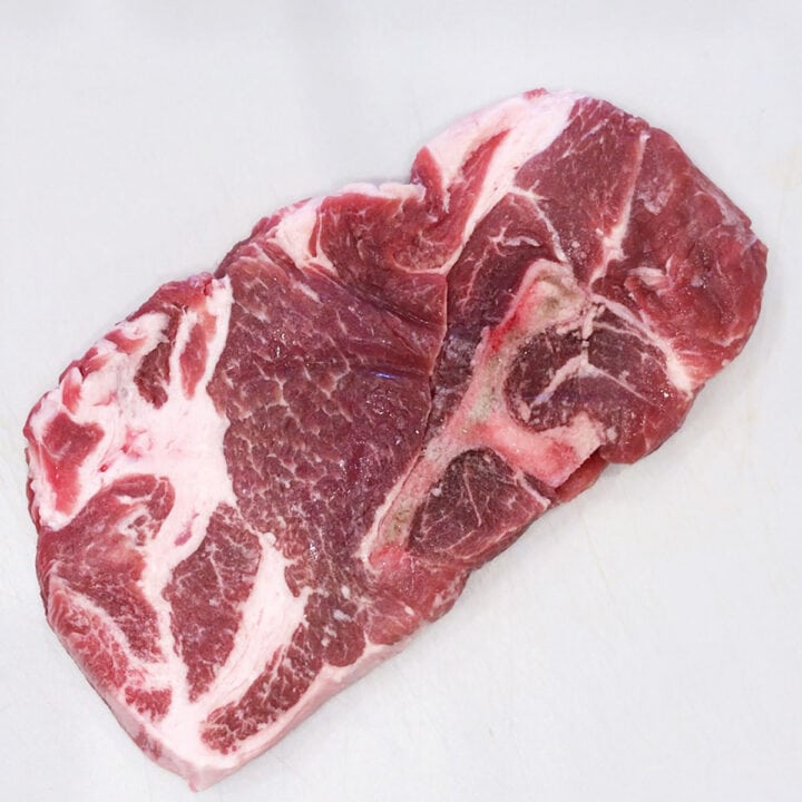 The steak on a cutting board.