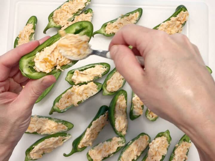Stuffing the jalapenos.