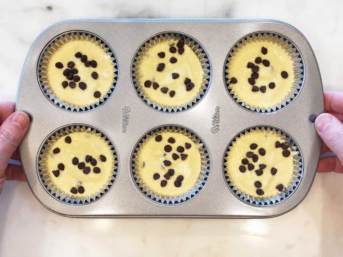 The batter was divided between muffin cups.