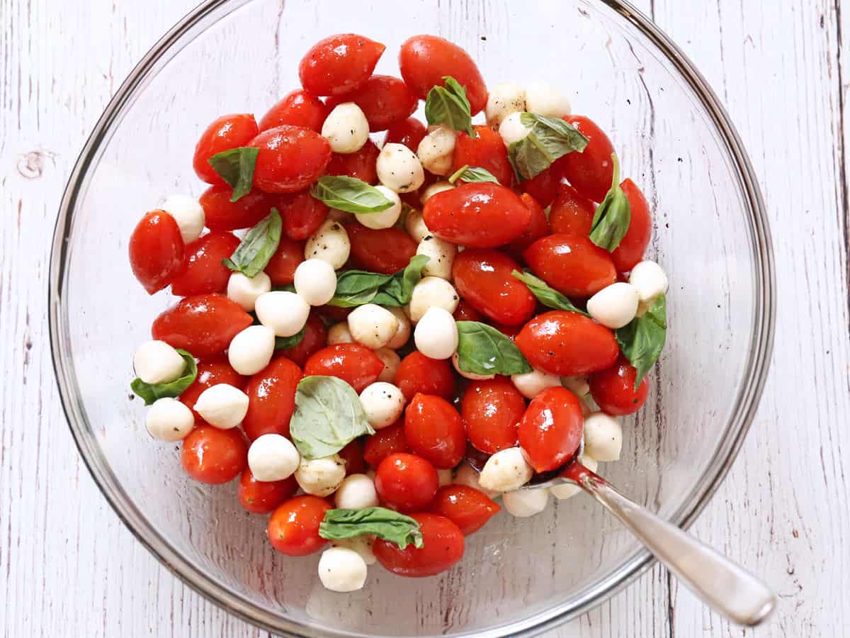 Caprese salad with cherry tomatoes and small mozzarella balls.