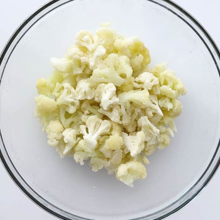 Steamed cauliflower florets in a bowl.