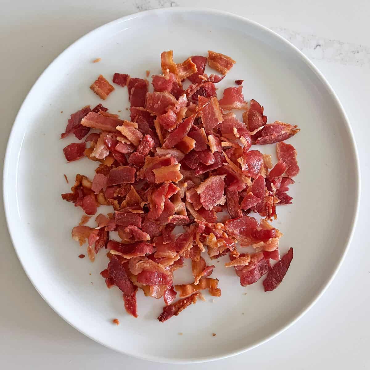 Chopped bacon on a plate.