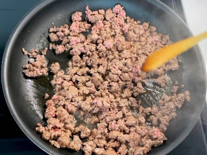 Cooking ground beef in a skillet.