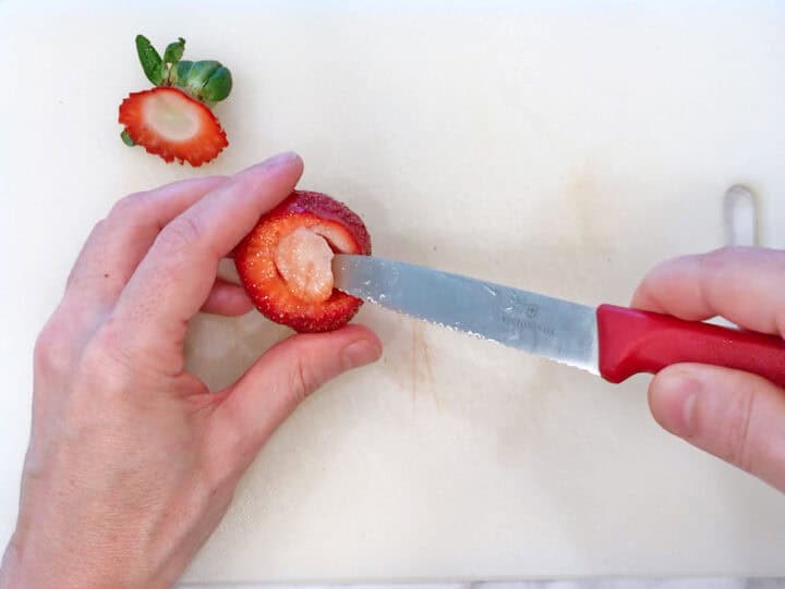 Coring a strawberry.