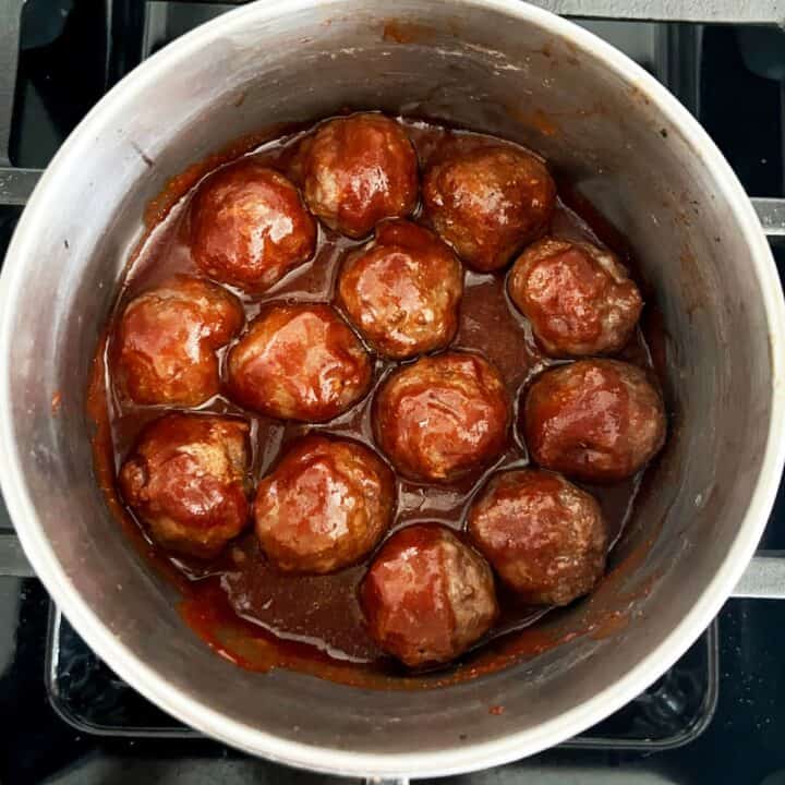 Cocktail meatballs are dipped in sauce.