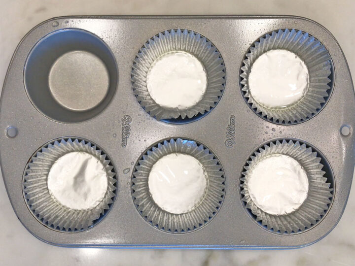Five greased muffin cups.