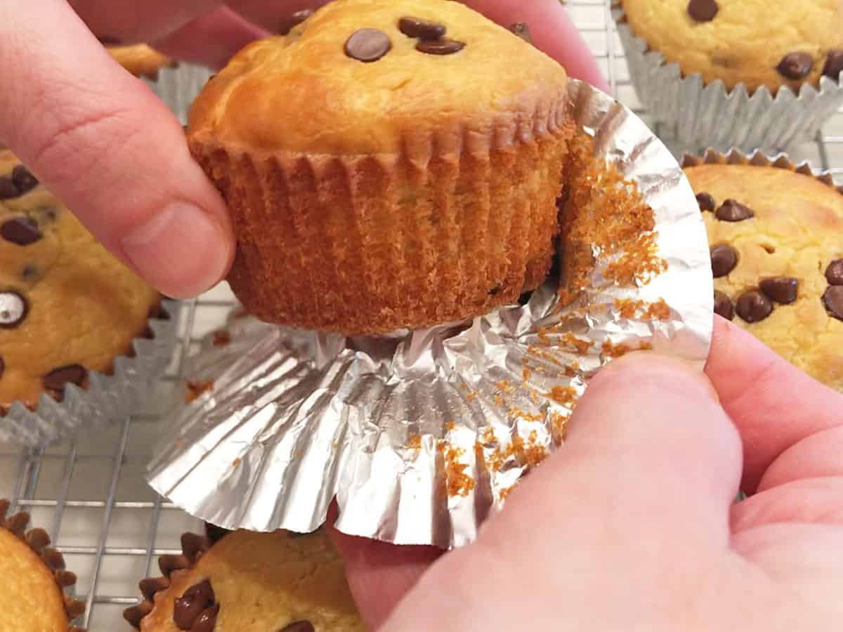 Removing a muffin from a foil liner.