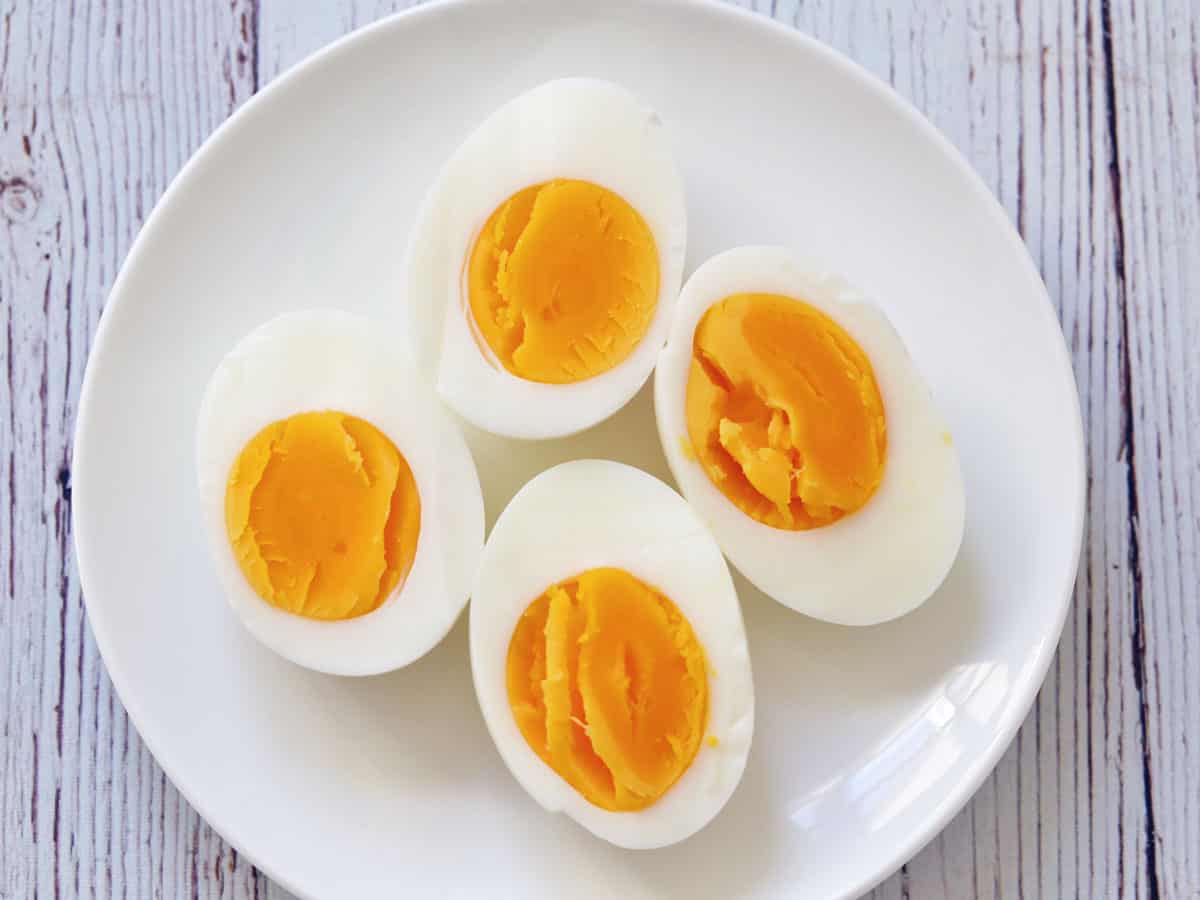 Hard-boiled eggs on a white plate.