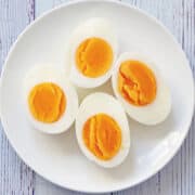 Hard boiled eggs on a white plate.