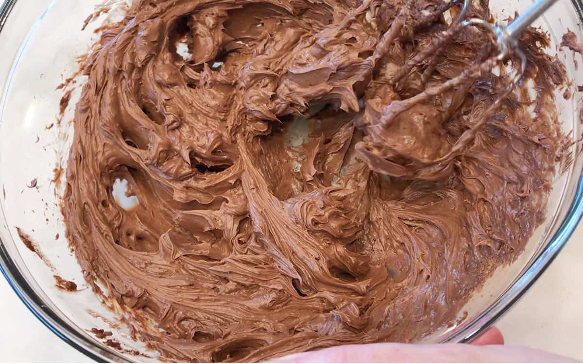 Mixing the frosting in a bowl.