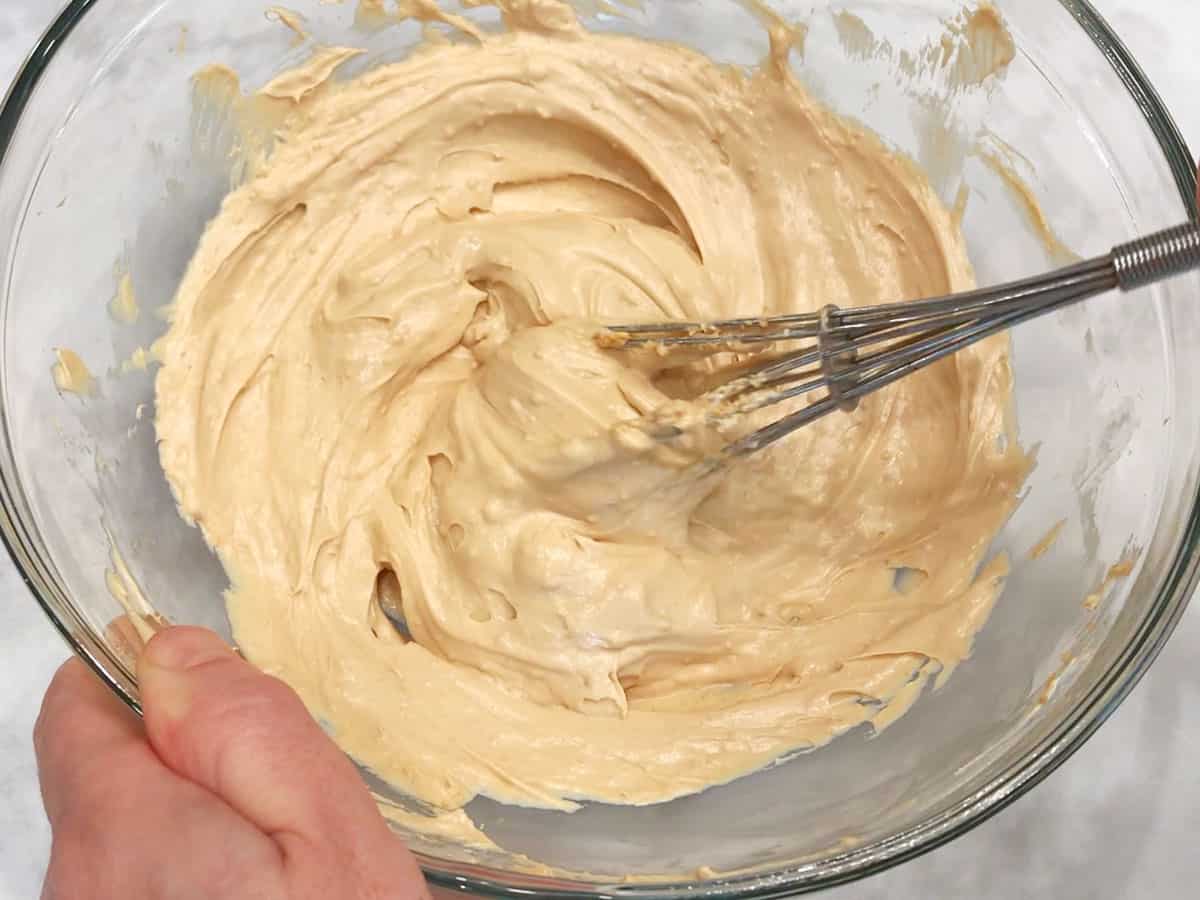 Mixing the frosting in a bowl.