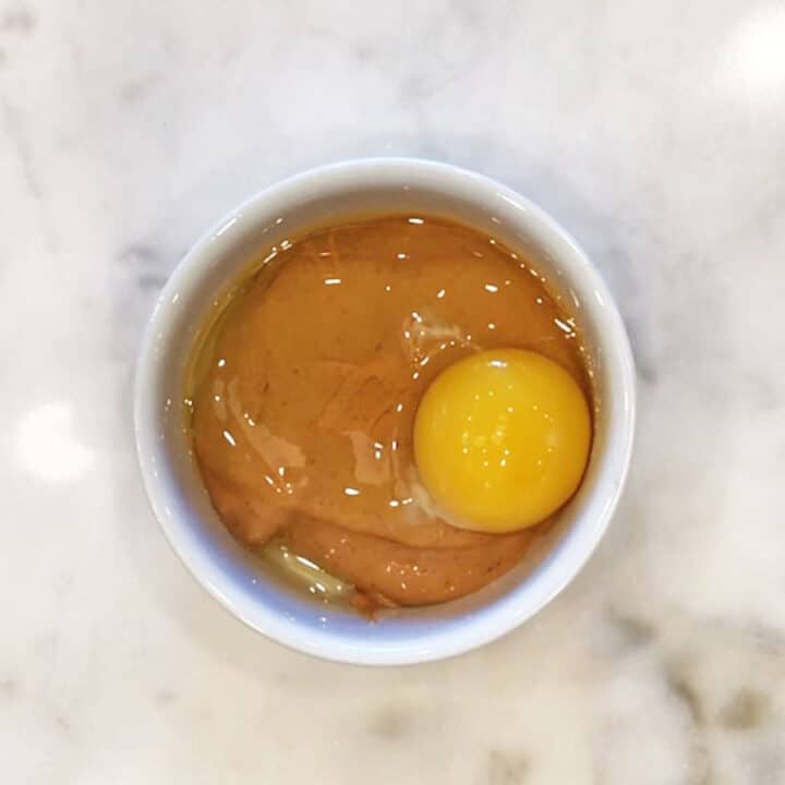 Peanut butter and egg in a ramekin.