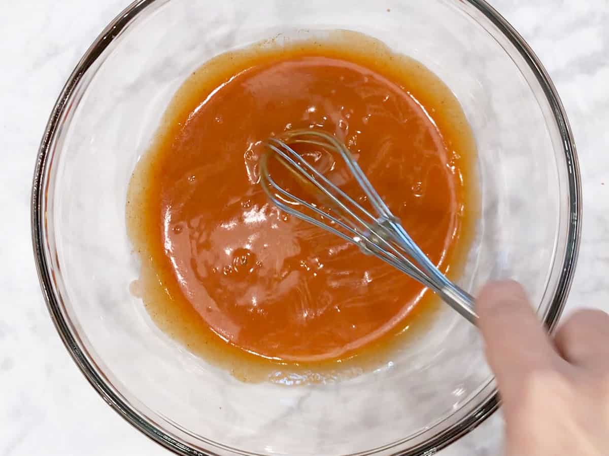 Mixing the buffalo sauce in a bowl.