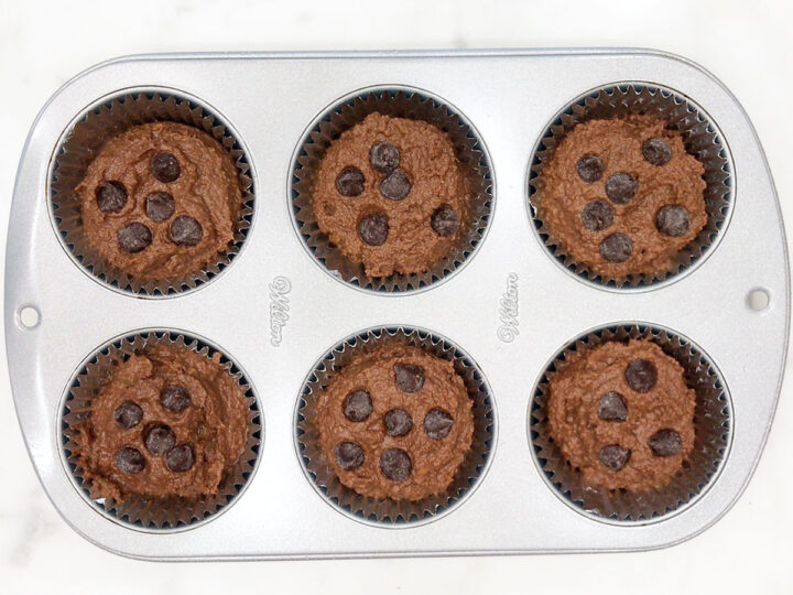 The muffin batter was divided between the muffin cups.
