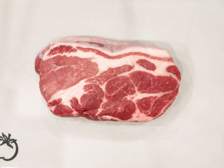 Pork shoulder on a cutting board.