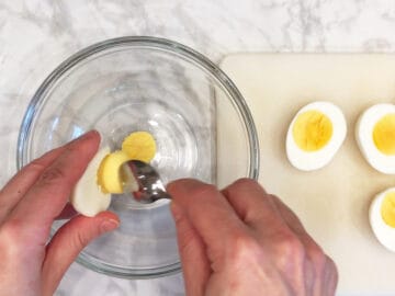 Removing the yolks to a bowl.