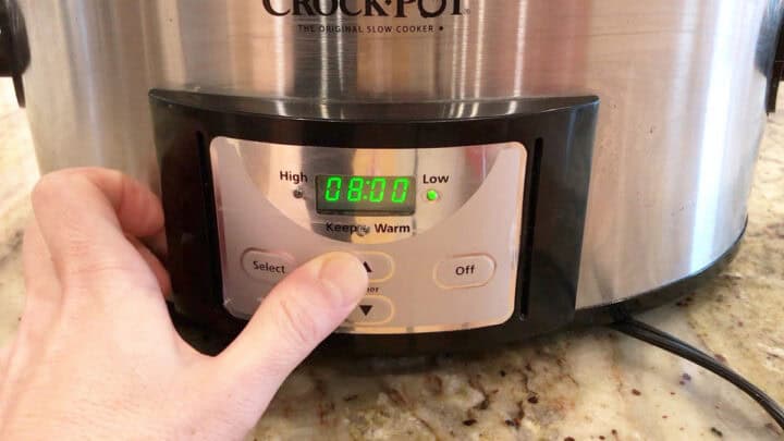 Setting the slow cooker to eight hours on LOW.