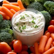 Sour cream dip is served with vegetables.