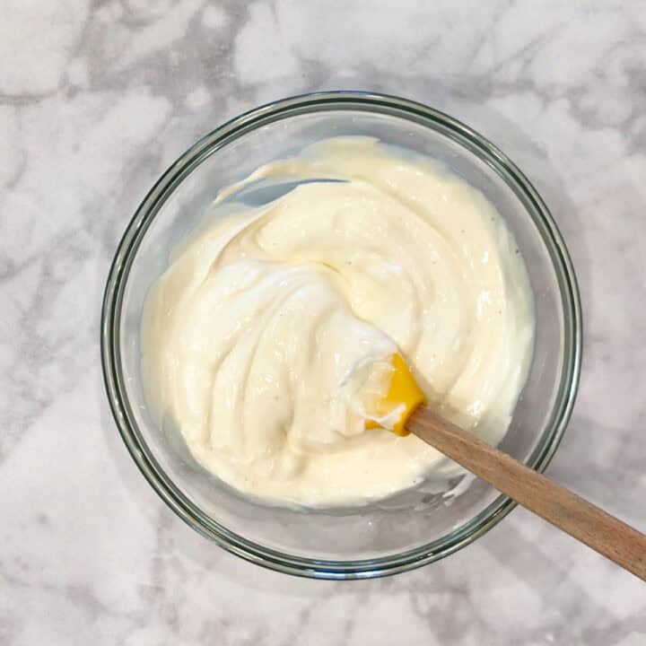 Mixing sour cream and mayo in a bowl.