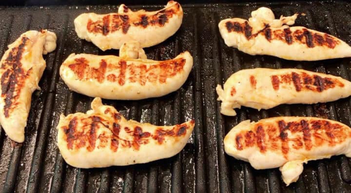 The chicken tenders are on the grill.