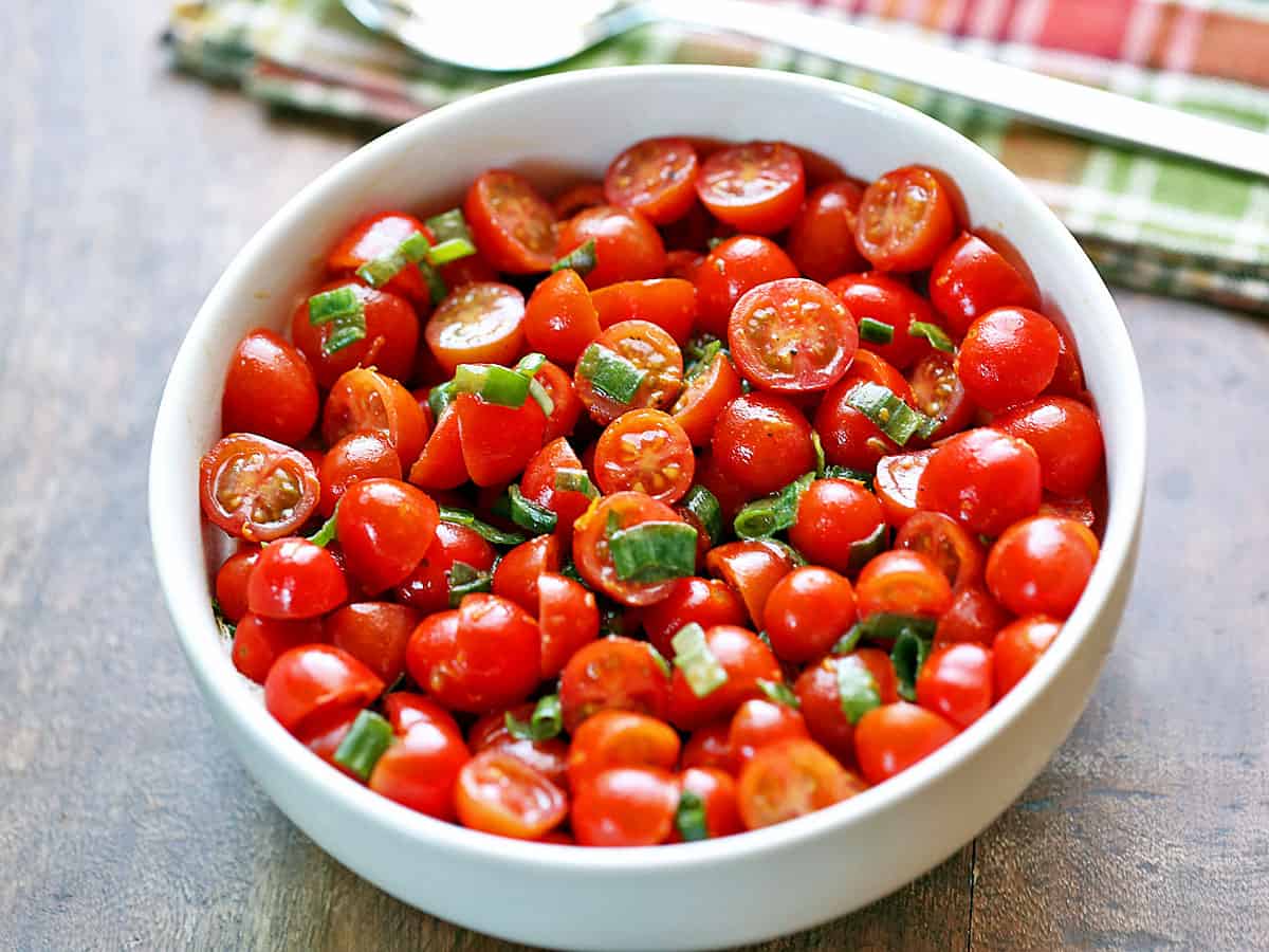 Cherry tomato salad is served in a bowl.