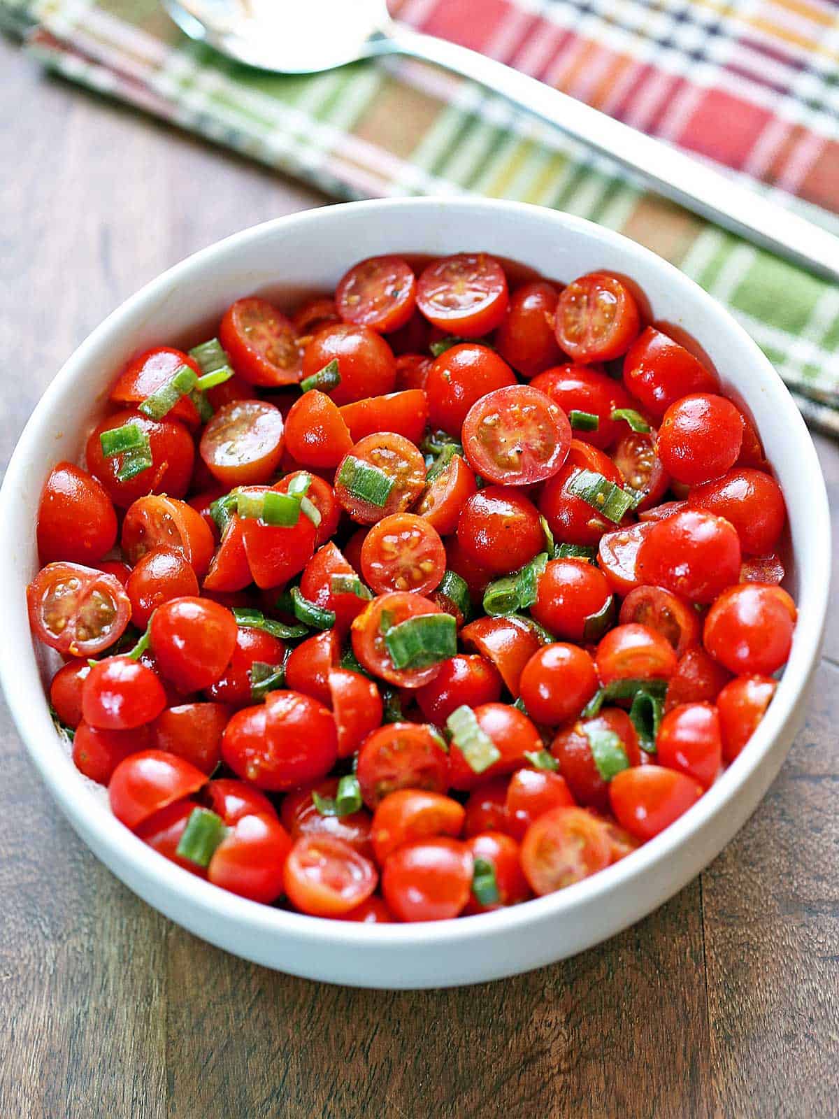 Cherry tomato salad is served in a bowl.