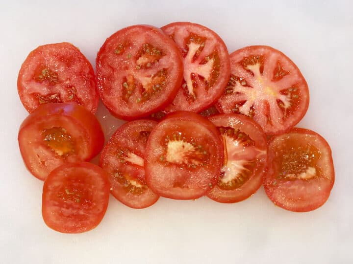Tomato slices on a cutting board.