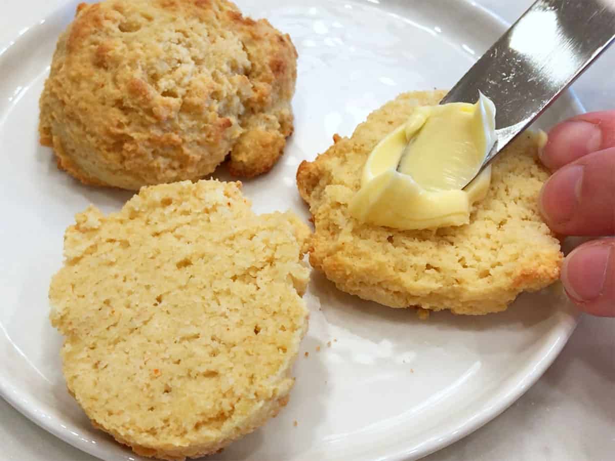 Topping the biscuits with butter.