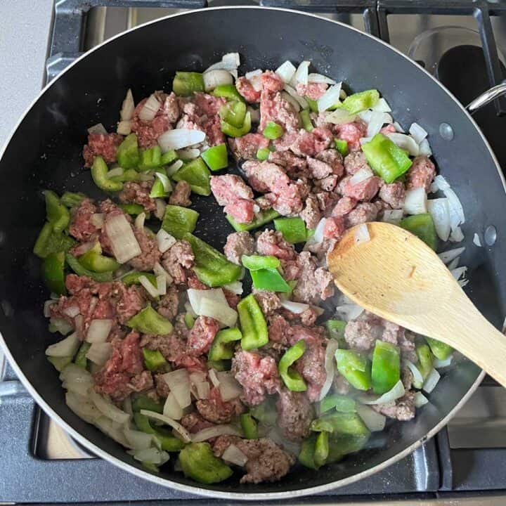 Browning the meat in the skillet.