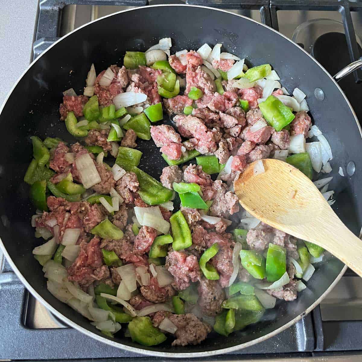 Browning the meat in the skillet.