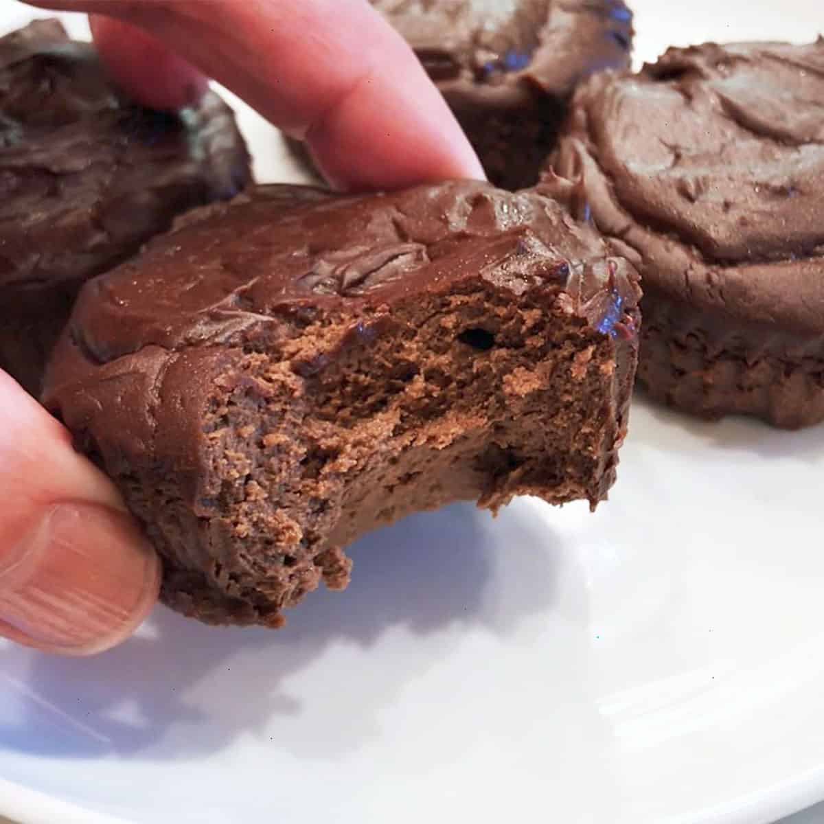 A bitten cake, showing off its fluffy inside.