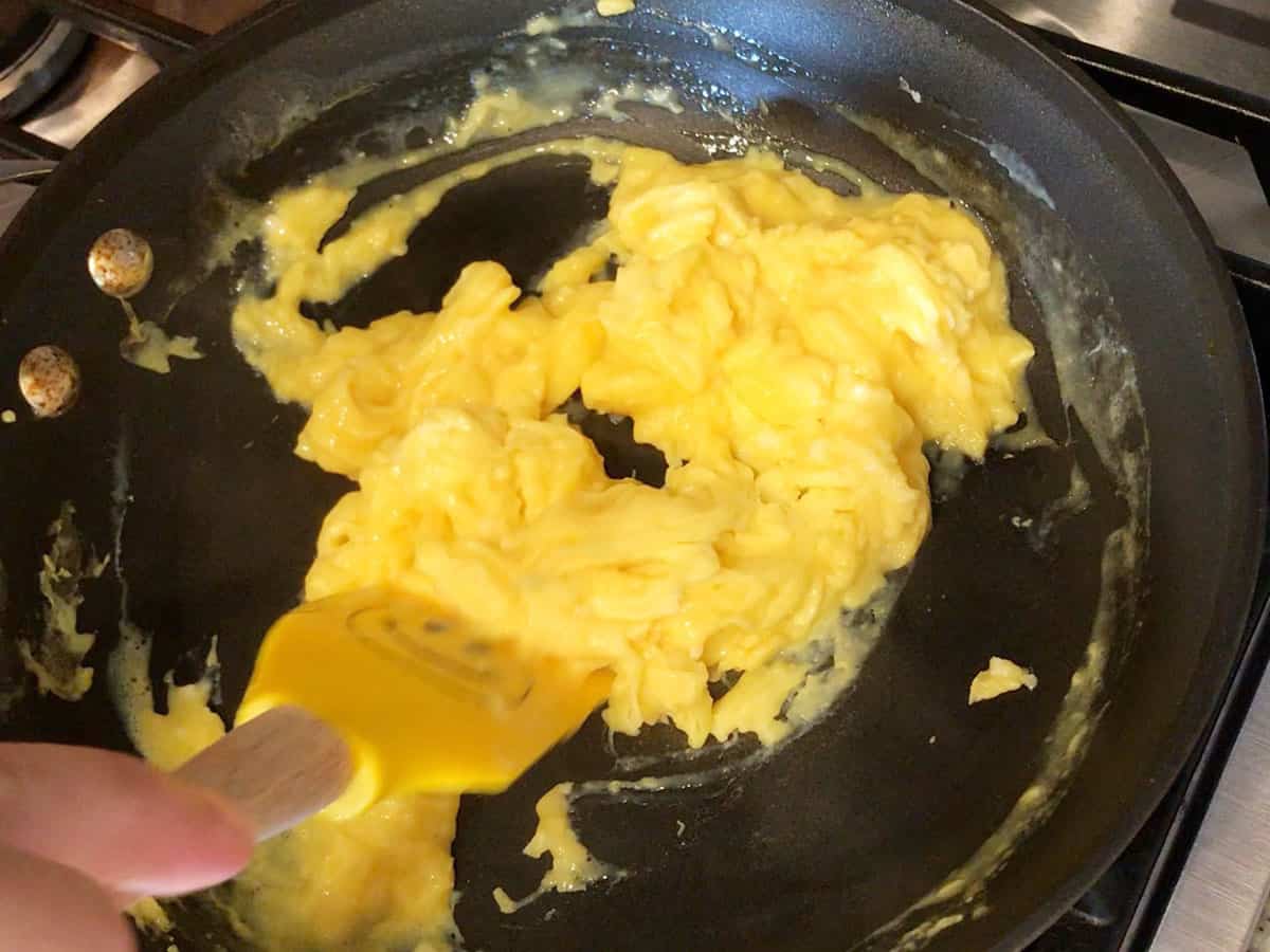 Cooking the eggs in the skillet.