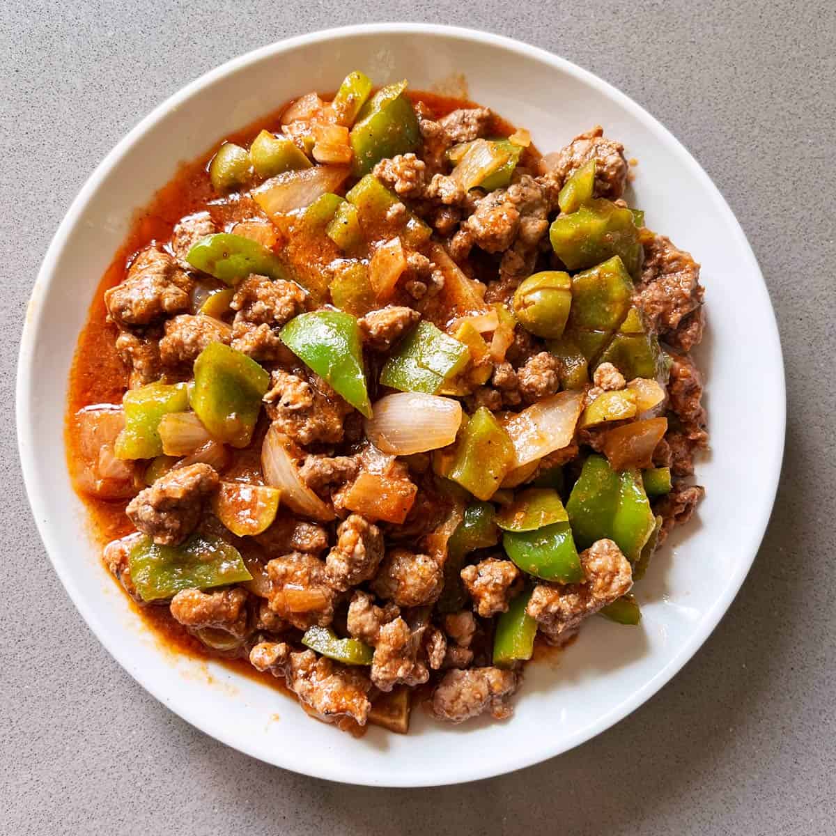 Picadillo is served on a white plate.