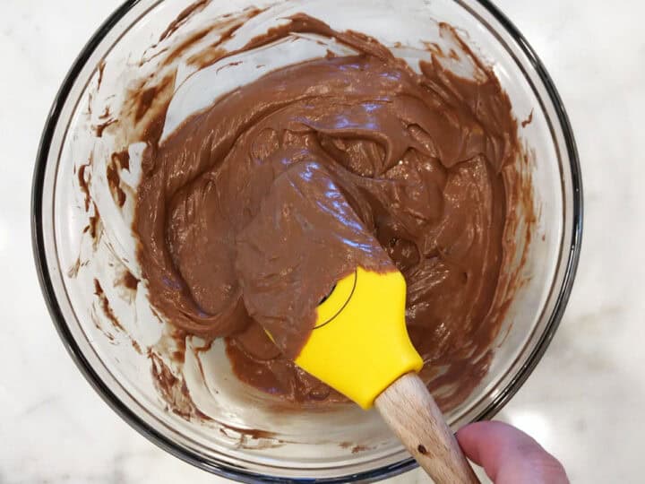 Remixing the batter with a rubber spatula.