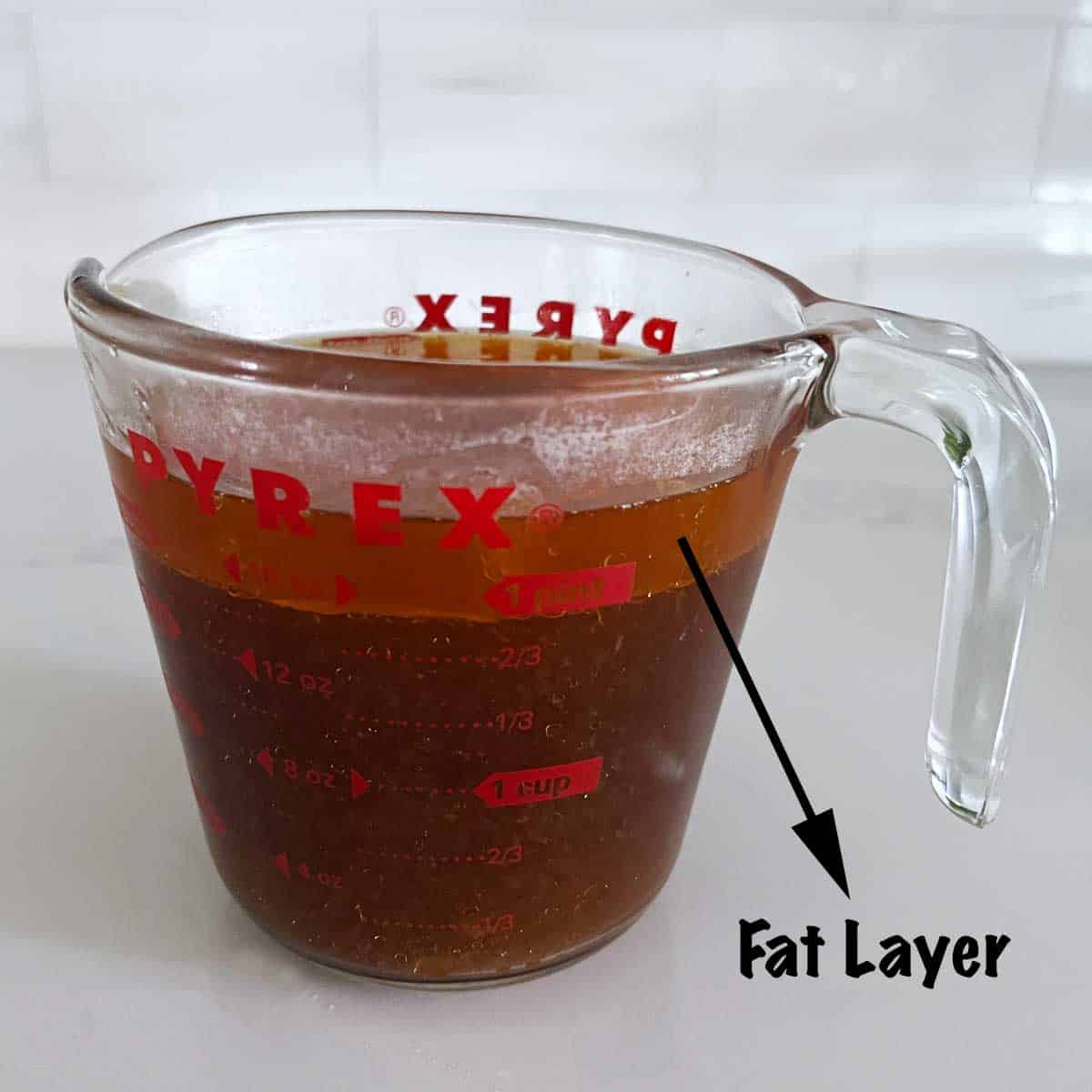 The fat layer on top of the cooking liquids.