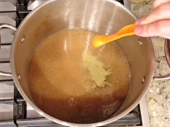 Broth and spices in a stockpot.