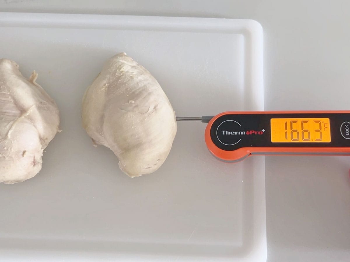 Measuring the chicken's internal temperature. It has reached 166.3°F.