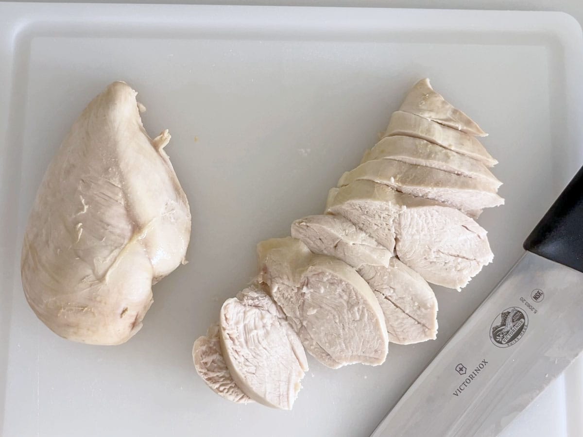 Slicing the poached chicken.