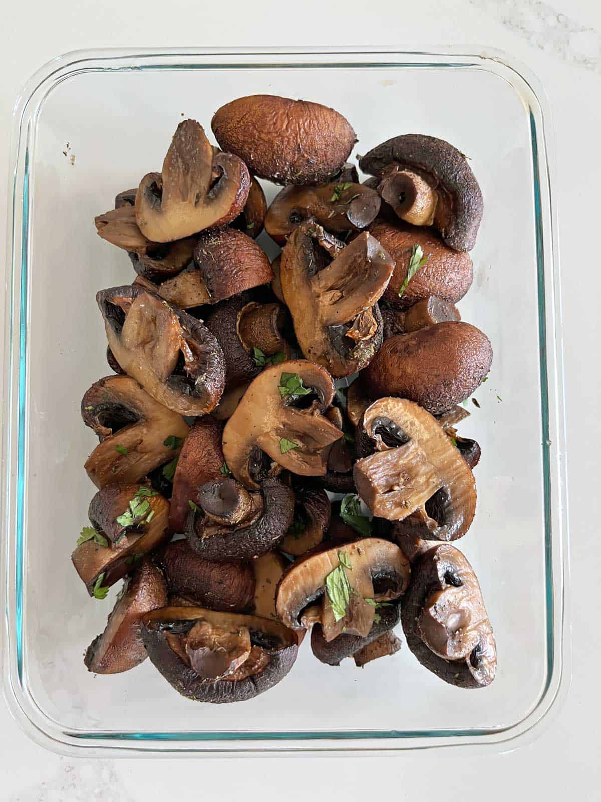 Leftover mushrooms are stored in a glass container.